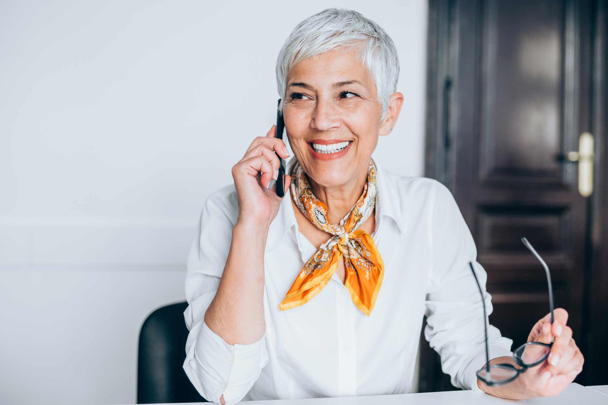 Woman talking on phone to her hearing specialist