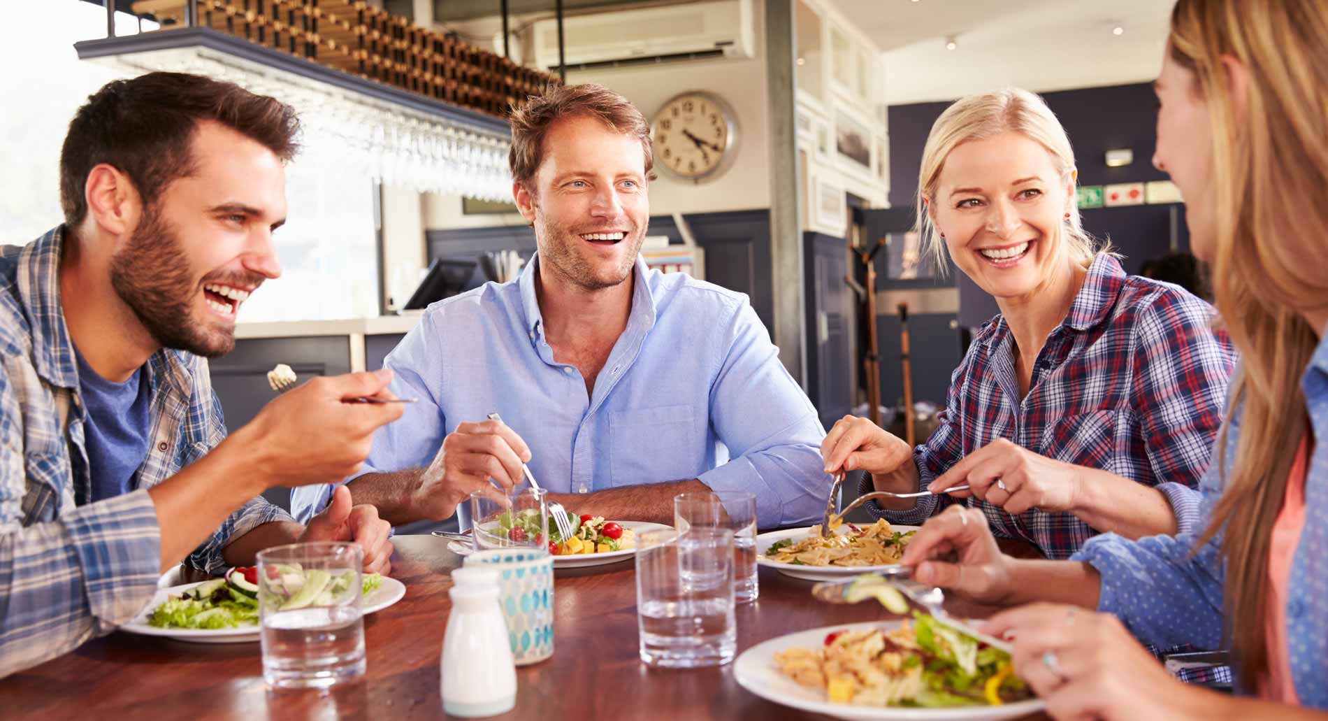 4 friends easily communicating in a Café in New York.